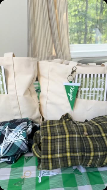Personalized Camp Landis canvas bags with green pennant name tags, styled with bachelorette gifts